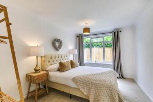 a bedroom with a bed and a window at LOCHIEL in Tatsfield