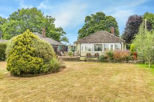 a house with a yard in front of it at LOCHIEL in Tatsfield