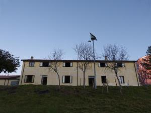 a building on a hill with trees in front of it at IL Casale del Galantuomo in Castelsaraceno