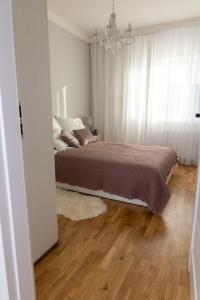A bed or beds in a room at Apartamenty Termalne Dobry Klimat