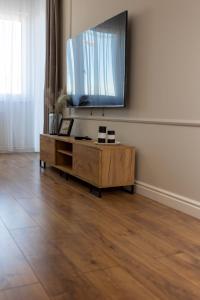a living room with a flat screen tv on a wall at Apartamenty Termalne Dobry Klimat in Uniejow