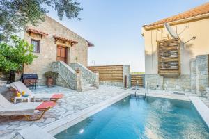 a house with a swimming pool in a yard at Olive Villas in Kría Vrísi