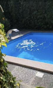 a swimming pool with a water fountain in it at Apartman MURKO P-2 