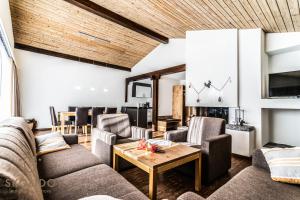 a living room with couches and a table at Haus Camillo in Saas-Fee