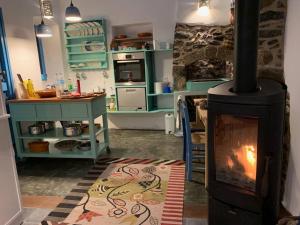 a kitchen with a wood stove in a room at Traumhaus Nisyros in Páloi