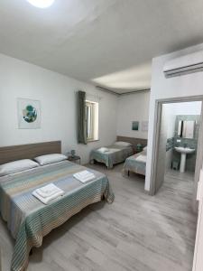 Ένα ή περισσότερα κρεβάτια σε δωμάτιο στο Oltremare