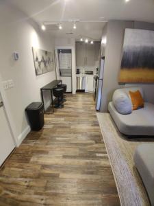 a living room with a couch and a kitchen at Inner Harbor's Best Furnished Luxury Apartments apts in Baltimore