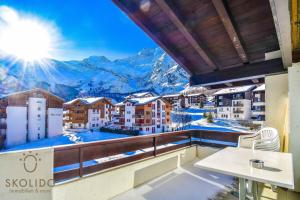 a balcony with a view of the mountains at Haus Camillo in Saas-Fee