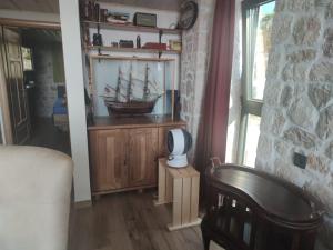 a room with a wooden cabinet with a ship in it at Stone Villa UK - Dobra Voda in Bar