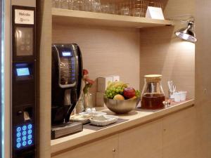 a kitchen counter with a cup of coffee next to a microwave at Casa Mathilda in Barcelona