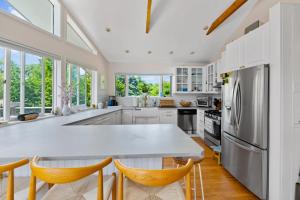 a kitchen with white cabinets and a table and chairs at Montauk Private Getaway in Montauk