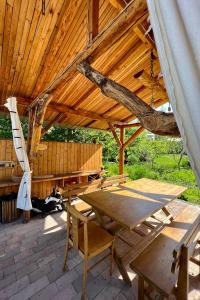 a wooden pavilion with a wooden table and a bench at Apple Tree Family Home (ECO) in Dzorakap