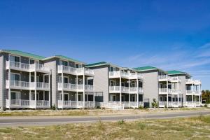 a row of apartment buildings on the side of a road at Seaside - Azure Dream B-302 in Virginia Beach