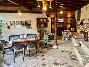 a living room with a table and chairs and a couch at Mystic Konak in Selçuk
