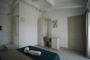 a bedroom with a bed and a desk in it at Villa Lentischio in Budoni