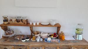 a wooden shelf with breakfast foods and drinks on it at Masseria Ferarelli Trepizzi in Diso