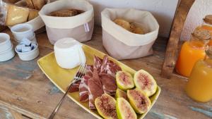 a table with a plate of figs and other foods at Masseria Ferarelli Trepizzi in Diso