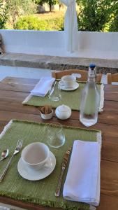 a table with plates and glasses and a bottle of milk at Masseria Ferarelli Trepizzi in Diso