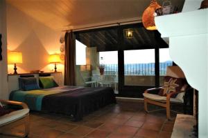 a bedroom with a bed and a large window at Loft con chimenea y terraza con vistas in Montsonis