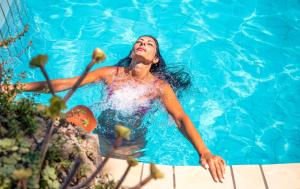 a woman in a blue dress in a swimming pool at Bristol Hotel in Ischia