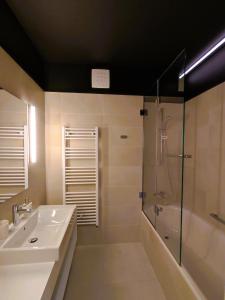 a bathroom with a sink and a shower at Silba - Luxury Apartment in Rabac +10 photos