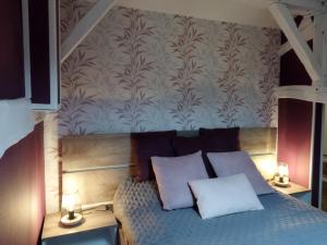 a bedroom with a bed with two white pillows at ESCAPADE CHAMPENOISE in Chavanges