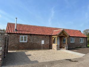a brick house with a red roof at The Old Parlour - With Hot tub and Dog Friendly! in Selby
