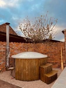 a hot tub in front of a brick wall at The Old Parlour - With Hot tub and Dog Friendly! in Selby