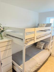 a bunk bed in a room with a desk at The Old Parlour - With Hot tub and Dog Friendly! in Selby