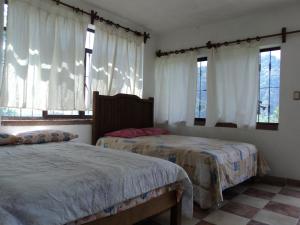 A bed or beds in a room at Posada Xamicalli