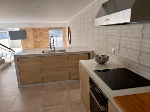 a kitchen with a sink and a counter top at Casa da Pedreira in Vila Baleira