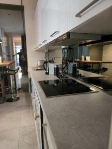 a kitchen with white cabinets and a counter top at Feel Home in Vienna in Vienna