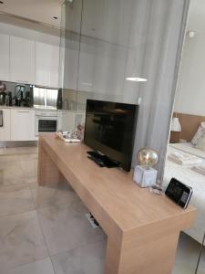 a living room with a large television on a wooden table at Feel Home in Vienna in Vienna +10 photos