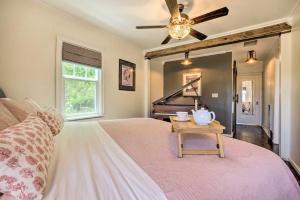 a bedroom with a bed with a table and a piano at The Old McCullough Home with Rooftop Deck, View in North Bend +29 photos