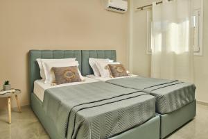 a bed with two pillows on it in a bedroom at Mariñeiro Apartment! in Zakynthos Town
