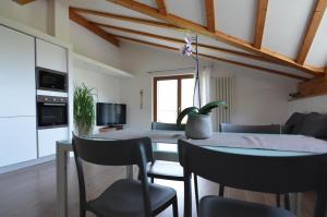 a kitchen and dining room with a table and chairs at Holiday home Danima in Pietramurata