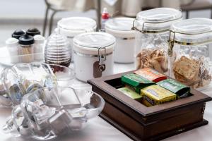 a table with a tray of food and jars of food at Hotel Alfa de Bauru Ltda in Bauru