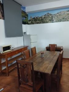a dining room with a wooden table and chairs at Hostel Rural Gaitanes, Caminito del Rey, Ardales in Ardales