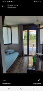 a bedroom with a bed and a view of a patio at MUSSES in Stratoni