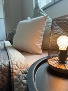 a lamp on a table next to a bed at Ferienwohnung Natur in Balingen