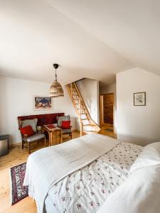 a bedroom with a bed and a desk and a staircase at Istebna 401 MURY in Istebna