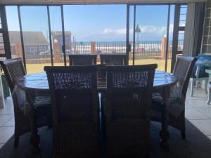a table and chairs with a view of the ocean at Eden Dunes 69 in Shelly Beach