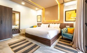 a hotel room with a bed and a blue chair at The Lemonary Marrakech in Marrakech