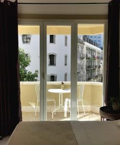 里斯本的住宿－Ey Lisbon GuestHouse，一间卧室设有一张桌子和椅子的阳台