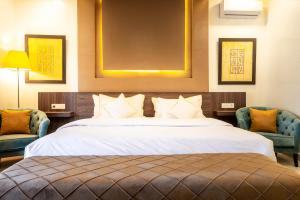 a hotel room with a bed and two chairs at The Lemonary Marrakech in Marrakech