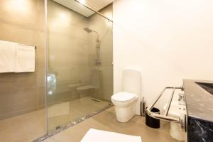 a bathroom with a toilet and a glass shower at The Lemonary Marrakech in Marrakech