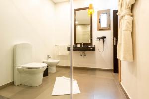 a bathroom with a toilet and a sink at The Lemonary Marrakech in Marrakech