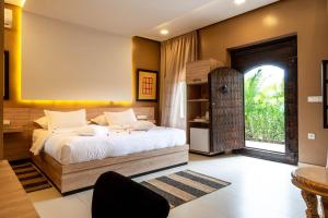 a bedroom with a large bed and a window at The Lemonary Marrakech in Marrakech