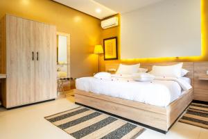 a bedroom with a large white bed and yellow walls at The Lemonary Marrakech in Marrakech