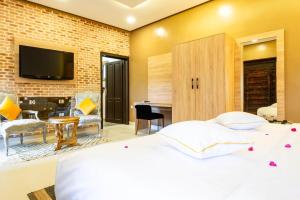 a bedroom with a bed and a living room at The Lemonary Marrakech in Marrakech